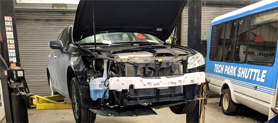 A vehicle up on the lift mid-repair